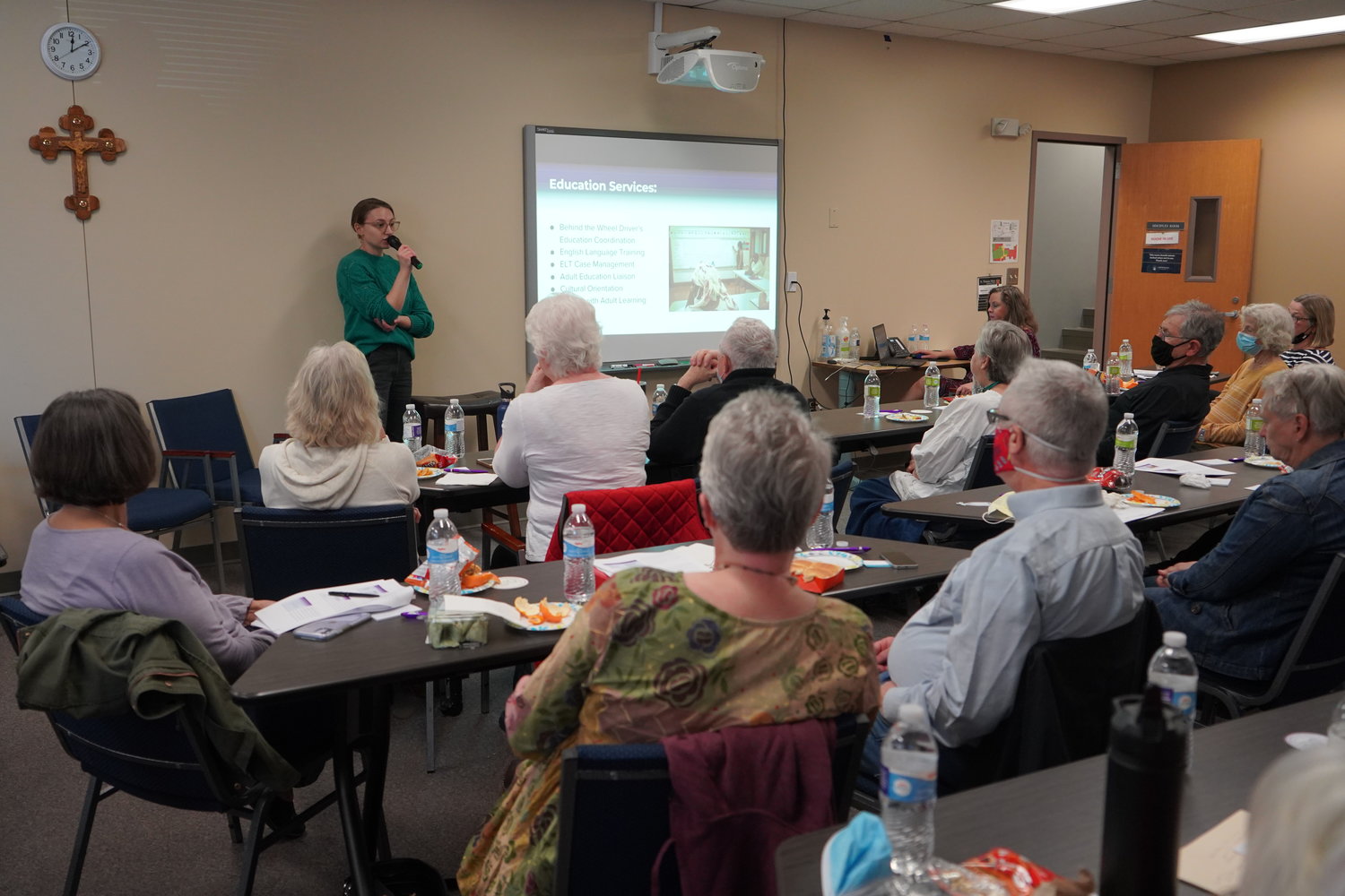 Samantha Moog, director of Refugee Services of Catholic Charities of Central and Northern Missouri, addresses volunteers during an orientation session for community sponsorship of refugees.